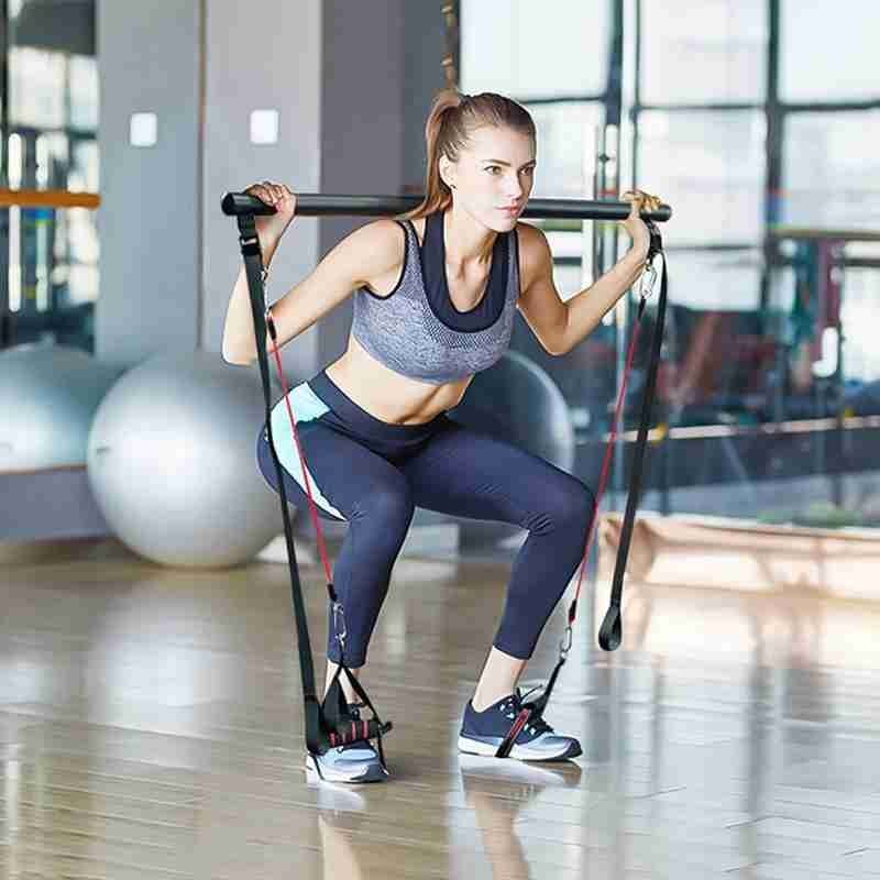 Woman exercising with resistance bands in a gym setting