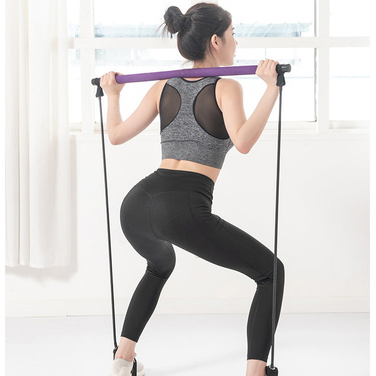 Woman exercising with resistance bands in a bright room