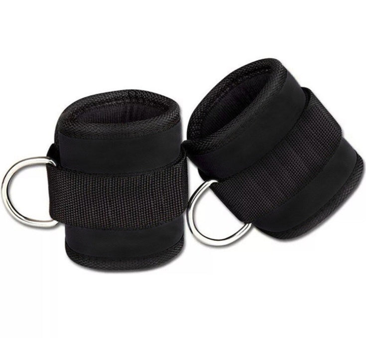 Pair of black wrist cuffs with metal rings on a white background