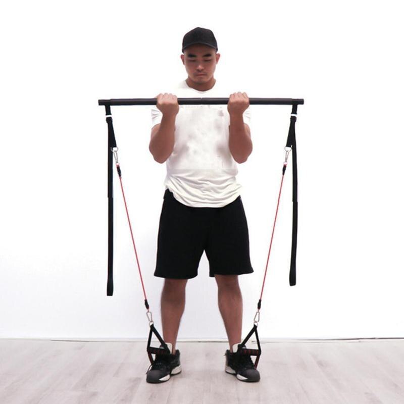 Person using a pull-up bar with resistance bands against a white background