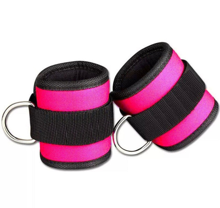 Pair of pink and black wrist straps with metal rings on a white background